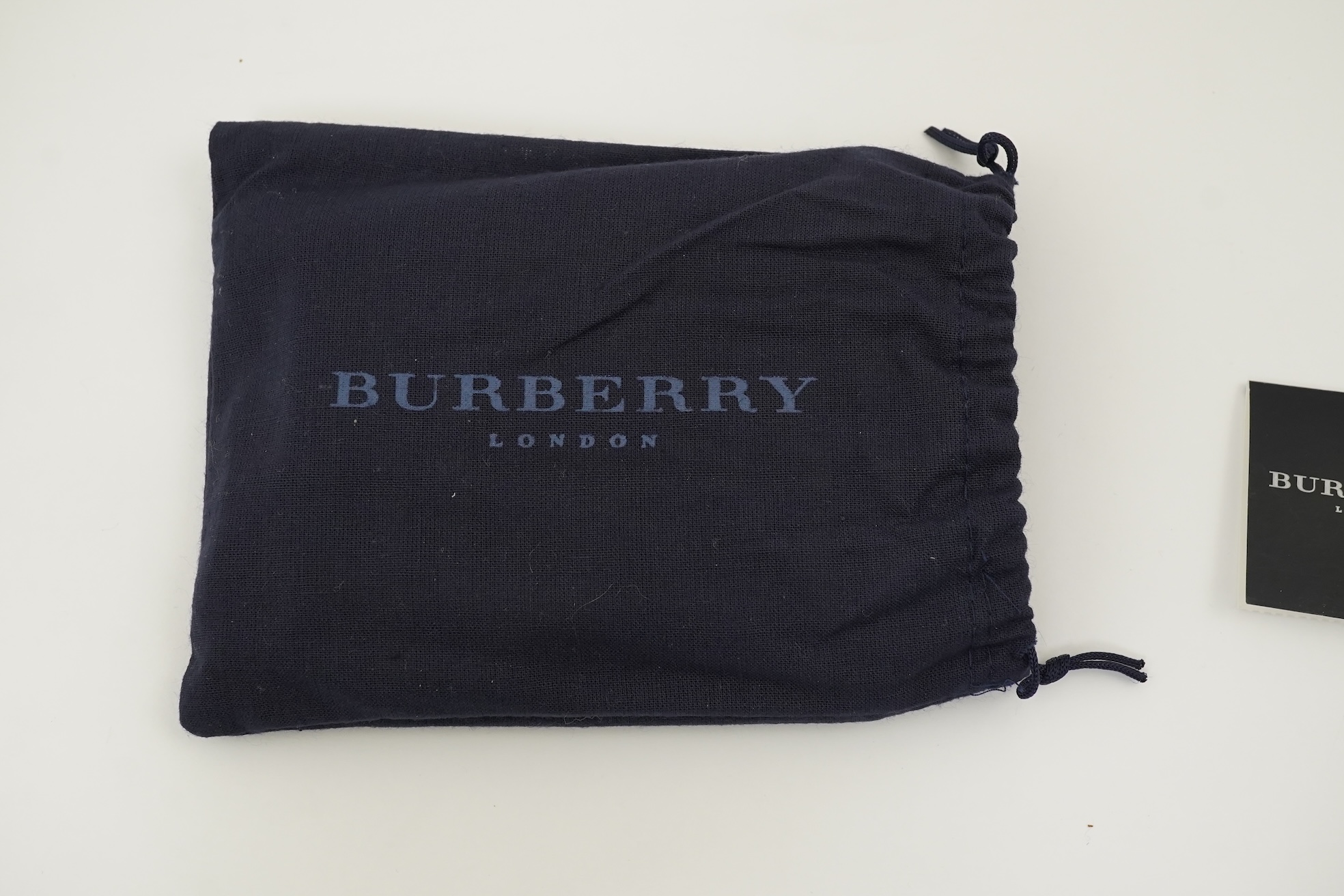 A Burberry brown tartan scarf, sunglasses with case and wallet with original box.